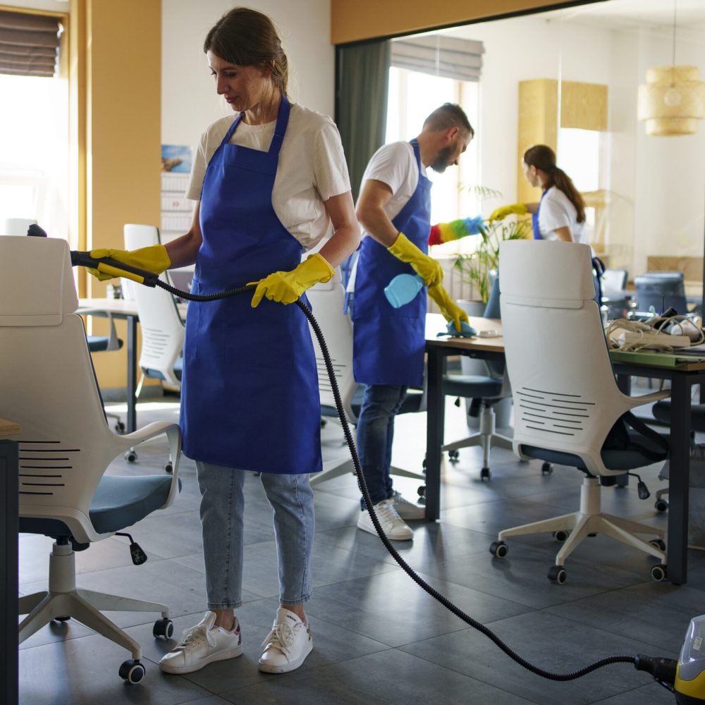 professional-cleaning-service-person-using-vacuum-cleaner-office